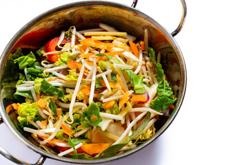 Colourful stir fry mixture in a wok - mixed vegetables with bamboo shoots and water chestnuts
