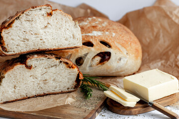 Savor Rustic Artisan Bread with butter, olives for a delicious blend of crunchy and rich flavors