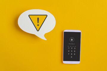 Online, mobile hacker, cyber crime concept, warning notification on real white speech bubble paper cut, and lock password on mobile phone with yellow background