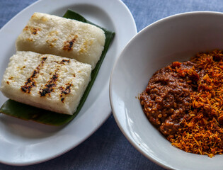 Ulen Traditional Food from Lembang, Indonesia, Grilled Sticky Rice, Coconut Flakes, and Peanut Sauce
