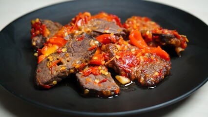 Lung beef (paru balado) cooked in spicy balado seasoning, which is sure to arouse appetite, selective focus and close up