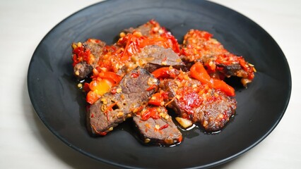 Lung beef (paru balado) cooked in spicy balado seasoning, which is sure to arouse appetite, selective focus and close up