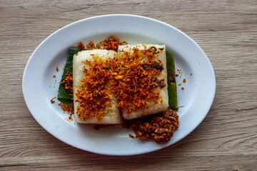 Ulen Traditional Food from Lembang, Indonesia, Grilled Sticky Rice, Coconut Flakes, and Peanut Sauce