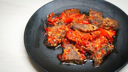 Lung beef (paru balado) cooked in spicy balado seasoning, which is sure to arouse appetite, selective focus and close up