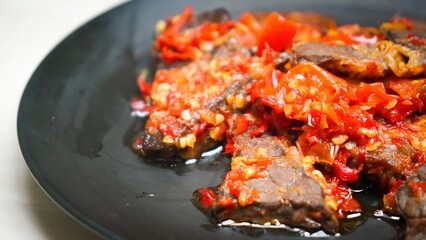 Lung beef (paru balado) cooked in spicy balado seasoning, which is sure to arouse appetite, selective focus and close up