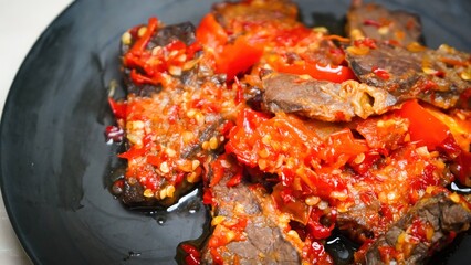 Lung beef (paru balado) cooked in spicy balado seasoning, which is sure to arouse appetite, selective focus and close up