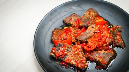 Lung beef (paru balado) cooked in spicy balado seasoning, which is sure to arouse appetite, selective focus and close up