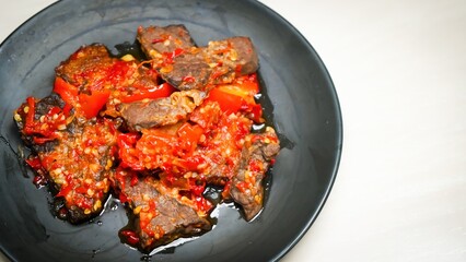 Lung beef (paru balado) cooked in spicy balado seasoning, which is sure to arouse appetite, selective focus and close up