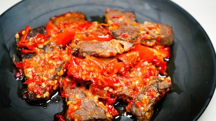 Lung beef (paru balado) cooked in spicy balado seasoning, which is sure to arouse appetite, selective focus and close up