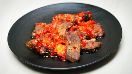 Lung beef (paru balado) cooked in spicy balado seasoning, which is sure to arouse appetite, selective focus and close up