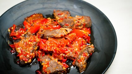 Lung beef (paru balado) cooked in spicy balado seasoning, which is sure to arouse appetite, selective focus and close up
