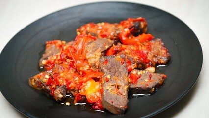 Lung beef (paru balado) cooked in spicy balado seasoning, which is sure to arouse appetite, selective focus and close up