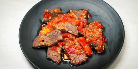 Lung beef (paru balado) cooked in spicy balado seasoning, which is sure to arouse appetite, selective focus and close up