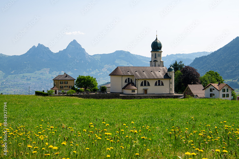 Wall mural St. Michael Church in Seelisberg, Switzerland. The mountains Kleiner Mythen and Grosser Mythen in the background.