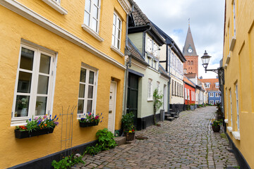 Fototapeta premium Hjelmerstald street in Aalborg, Denmark. Church of Our Lady in the back
