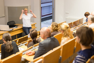 Instructor teaching first aid cardiopulmonary resuscitation course and use of automated external...