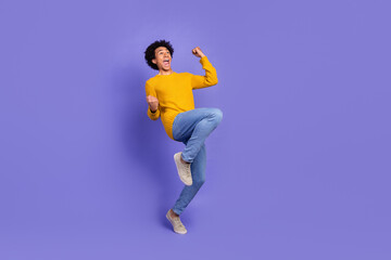 Photo of cheerful glad funky man wear stylish yellow clothes scream hooray empty space isolated on purple color background