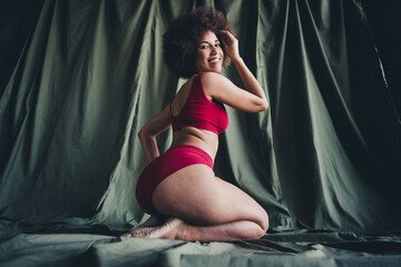 Unretouched photo of happy girl sit knees love herself isolated khaki color linen background