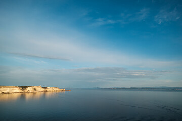 Evening sun on the cliffs of Bonifacio and Mediterranean sea on the south coast of Corsica with the coastline of Sardinia in the distance