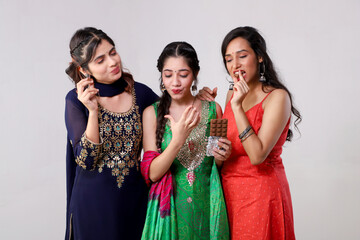 Obraz premium Beautiful Female Models Enjoying Eating Delicious Chocolate