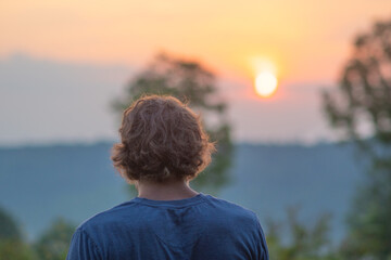 Morning sunrise woodland landscape fog, copy space selective focus natural background, man in foreground looking out landscape sunrise.