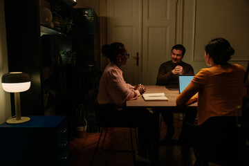 Fototapeta premium Three office coworkers working late at night