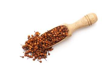 Top view of a wooden scoop filled with Organic Ceylon Ironwood or Nagkesar (Mesua ferrea) seeds. Isolated on a white background.