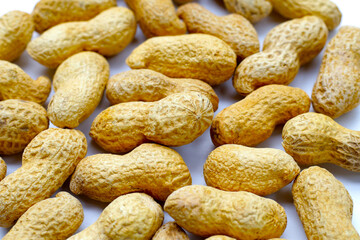 Roasted peanuts in shell on white background.