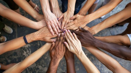 A group of diverse hands come together in a circle, showcasing unity and teamwork