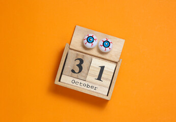 Happy Halloween. Calendar with date October 31 and eyeballs on orange background