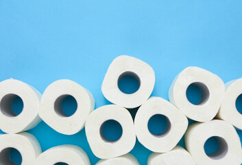 Lots of toilet paper rolls on blue background. Top view