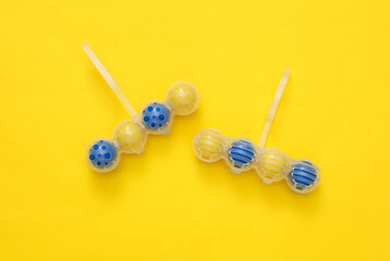 Toilet rim block cleaners on yellow background. Top view