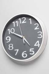 Large round wall clock on a gray background