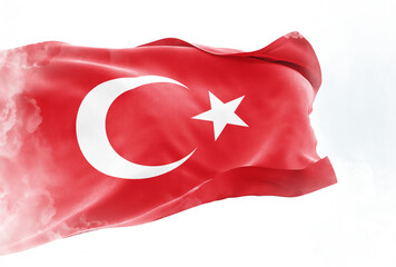The national flag of Turkey waves in the wind. The waving flag of Turkey. Close-up front view. Clouds in front of the flag.