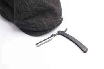 Straight razor with eight-bladed cap on a white background