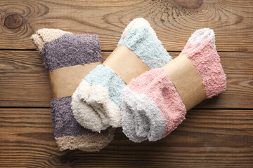 New socks with wrapped tags on wooden background