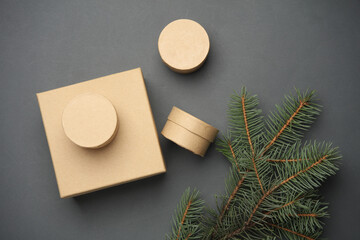 Craft boxes and a pine twig on a dark background