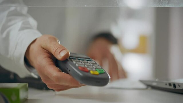 Counter. The pharmacist applies experience using electronic equipment to pay in a drug store. An experienced employee uses a bank card for payments and adheres to the rules of the pharmacy