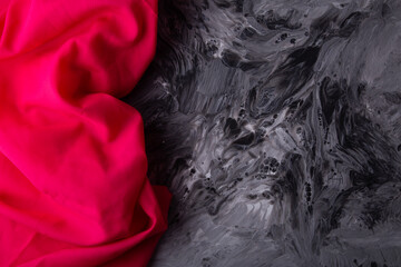 Contrast with pink fabric on dramatic gray swirl background