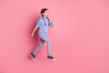 Full body portrait of cute little schoolkid jump run empty space wear hoodie isolated on pink color background