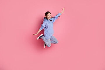 Full body portrait of cute little schoolkid jump empty space wear hoodie isolated on pink color background