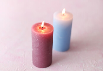 Flaming candles on a pink background. Romantic atmosphere