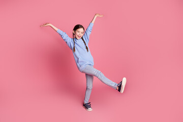 Full body portrait of cute little schoolkid dancing wear hoodie isolated on pink color background