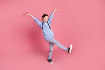 Full body portrait of cute little schoolkid dancing wear hoodie isolated on pink color background