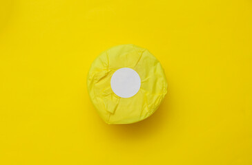 Paper product packaging with white sticker on yellow background