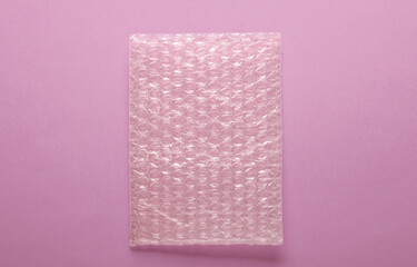 Shockproof wrapping film with bubbles for transportation on pink background