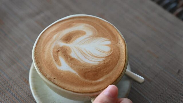 Beautiful cup with cappuccino drink