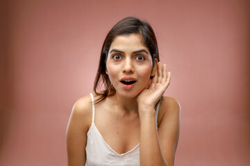 Mischievous Girl In White Top Listening To Someone Talk