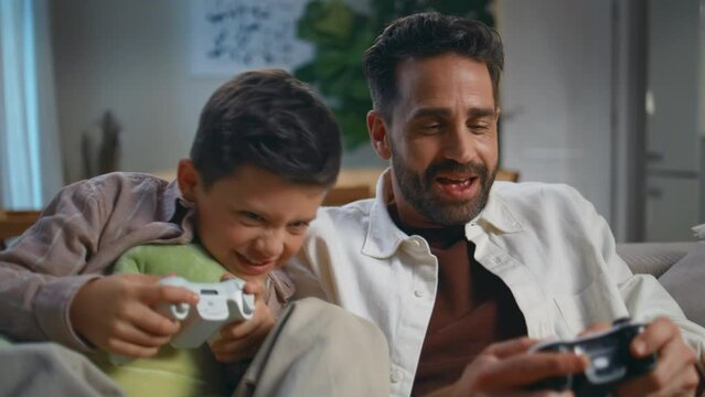 Man boy gaming console at evening home closeup. Dad child playing video game