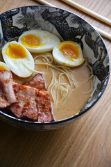 Bowl of miso ramen soup on wooden table